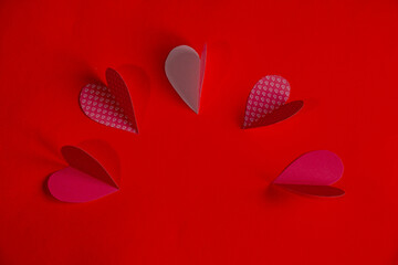 Hearts laid out in a semicircle on a red background