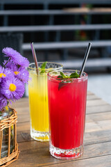 Colorful summer lemonades in glasses with ice and metal straws