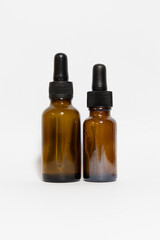 two amber glass medicine bottles on white background