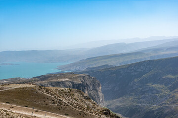 view of the Chirkeyskoye reservoir with a background of blue sky and mountains. natural light.
