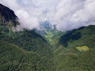 Obraz premium Green Mountains Surrounded by Crops on a Slightly Cloudy Day in Salento, Quindío, Colombia 