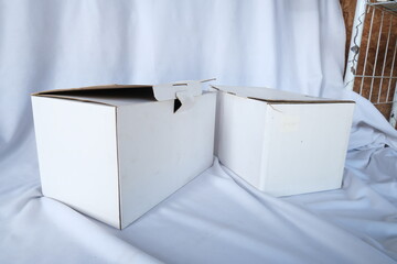 White Cardboard Box on Fabric Surface for Versatile Packaging and Mockup Design Projects