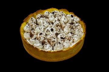 Traditional banoffee cake with banana and caramel sauce filling sprinkled with grated dark chocolate and coffee . English traditional pie