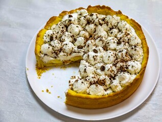 Traditional banoffee cake with banana and caramel sauce filling sprinkled with grated dark chocolate and coffee . English traditional pie