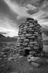 Rock Stack Smelter BW. A round rock stack smelter used to extract minerals from ore. Located in the ghost town site of White Mountain City, CA.