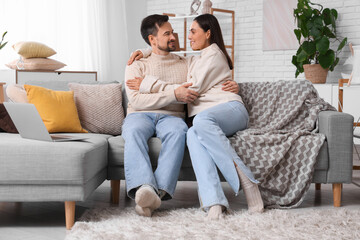 Young couple hugging at home on autumn day