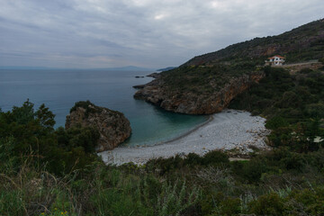 Famous rocky beach Foneas near Kardamyli village with turquoise colored water in spring time, Messinia, Peloponnese, Greece