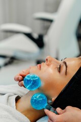 Rejuvenating facial treatment with cooling gel balls at a spa