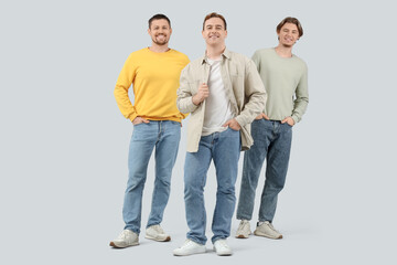 Fototapeta premium Young men in jeans on light background