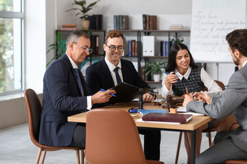 Group of lawyers working at table in office