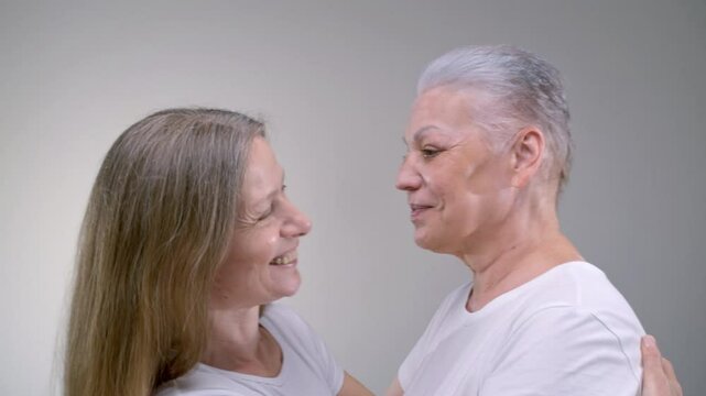 Close up portrait two old women hugging. Family monogamous love of the same sex. Gender self identification. Senior females are laughing and happy, smiling. Older mother, relationship, support or care