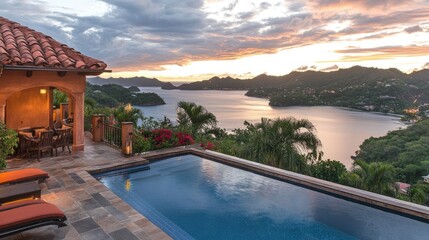 Luxurious outdoor terrace of a villa with an infinity pool, tropical views, and red festive decor under sunrise glow
