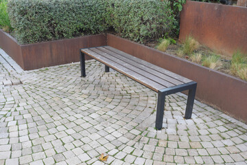 A Modern Outdoor Bench Elegantly Surrounded by Beautiful Greenery