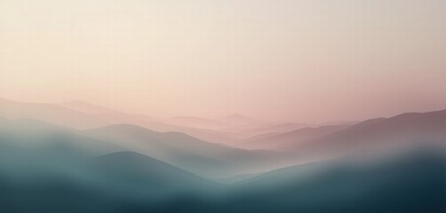 Fototapeta premium Misty morning wallpaper image of mountains with fog and clouds over hills and valleys at sunrise
