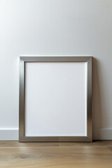 Silver mock up poster frame on the wooden floor by the wall
