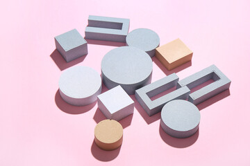 Composition with different building blocks on pink background