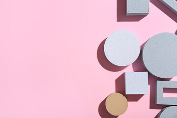 Composition with different building blocks on pink background