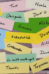 Thank you written in multiple languages on colorful paper notes
