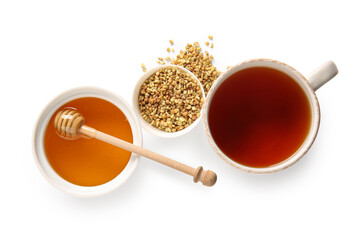 Cup of hot buckwheat tea and bowl with honey on white background