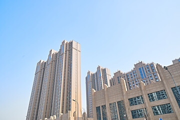 Fototapeta premium Looking up at modern office buildings and local landscape
