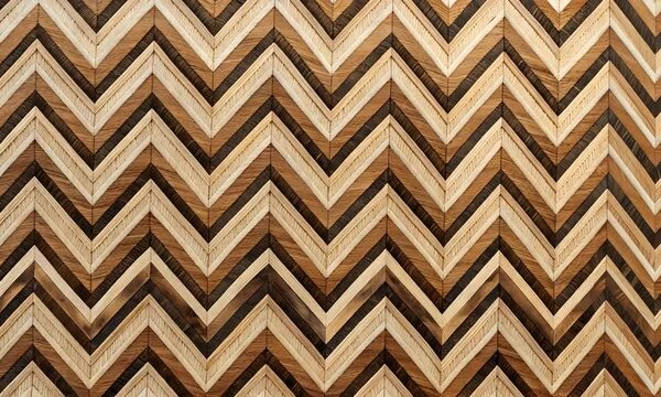 A geometric pattern featuring zigzagging lines in various shades of brown and cream, creating a visually striking design ideal for interior decoration or artwork.