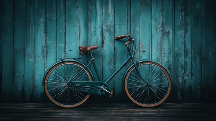 Vintage teal bicycle against teal wooden wall.