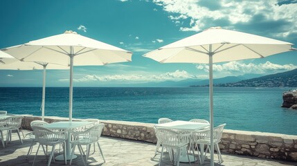 Fototapeta premium Coastal cafe patio, sunny ocean view, tables, umbrellas