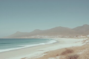 Serene Beach Landscape with Gentle Waves and Mountains