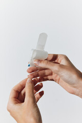 Two people with white bandages on their fingers holding small pieces of plastic