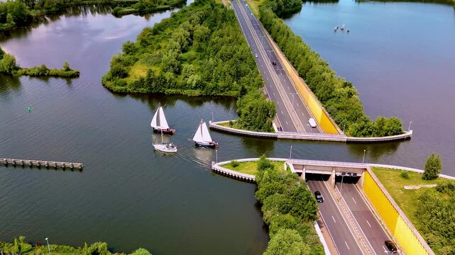 Journey to the Veluwemeer Aqueduct Netherlands, where boats glide effortlessly above the road. This engineering marvel harmonizes nature with transportation in a picturesque setting.