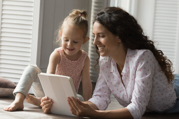 Family activities online. Portrait happy friendly parent little kid young mom daughter preschooler...