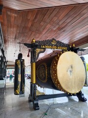Large wooden bedug drum with ornate carvings at a Masjid Agung. Symbol of Islamic prayer and community. Great Mosque of Demak
