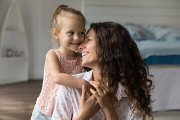 Simple joy of parenthood. Portrait affectionate little daughter hug beloved mommy from back snuggle to dear mom feel bonding grateful for support love care endearment greet with birthday Mother Day