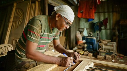 Artisans standing operating in timber workshop