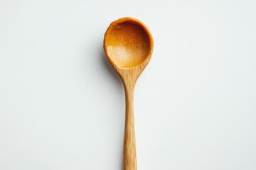 Wooden spoon with honey; shows texture and color. Perfect for food blogs, recipes, or honey product advertising.