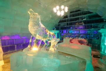 The dreamy ice room in the ice castle is illuminated by colorful lights and shadows