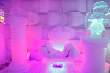 The dreamy ice room in the ice castle is illuminated by colorful lights and shadows