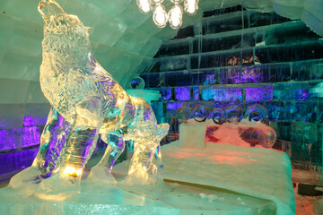 The dreamy ice room in the ice castle is illuminated by colorful lights and shadows