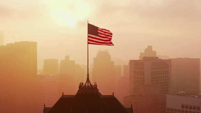 Aerial Drone Shot of American Flag Waving at Sunrise Over San Francisco Skyline and Nob Hill, California