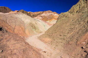 A rocky, hilly landscape with a path running through it