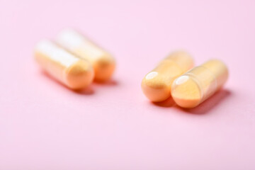 Coenzyme Q10 capsules. Antioxidants. Concept for a healthy dietary supplementation. Bright paper background. Soft focus. Close up. Copy space.