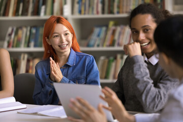 Bright plan. Smiling adolescent students of diverse ethnicities brainstorming at group class in...
