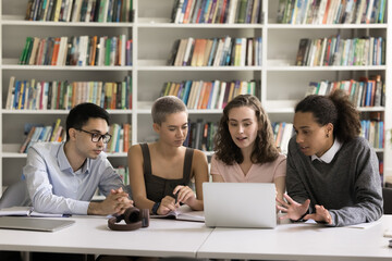 Tech and study. Four diverse multicultural schoolmates students friends using laptop in learning at...