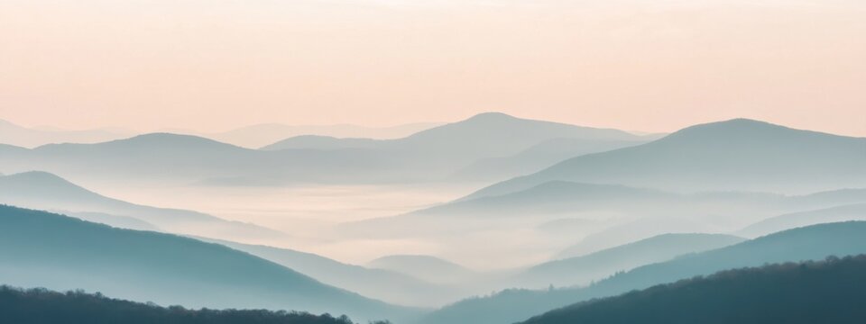 A tranquil view of a misty mountain landscape with layers of rolling hills fading into the distance, bathed in the soft light of dawn, Misty mountains scene