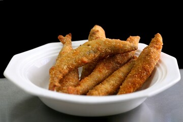 Crispy fried fish sticks in a bowl