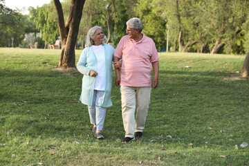 Indian happy senior beautiful couple embracing tohether and looking romantic and close together in...
