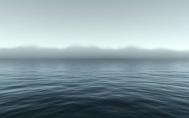 Misty ocean landscape with distant hills.