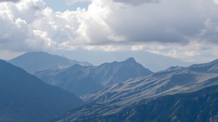 Majestic mountain range landscape photo showcasing dramatic cloud formations over rolling hills and valleys.
