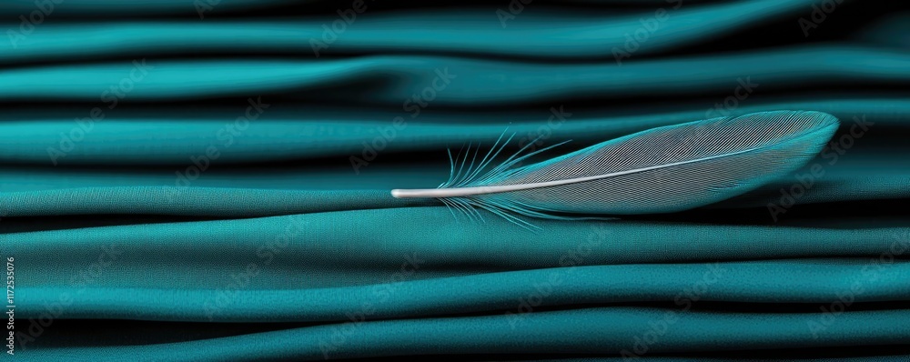 Poster feather abstract background idea. a delicate feather rests on soft teal fabric, symbolizing softness