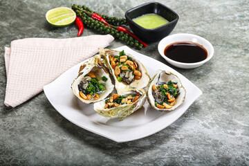 Open half oysters with green onion